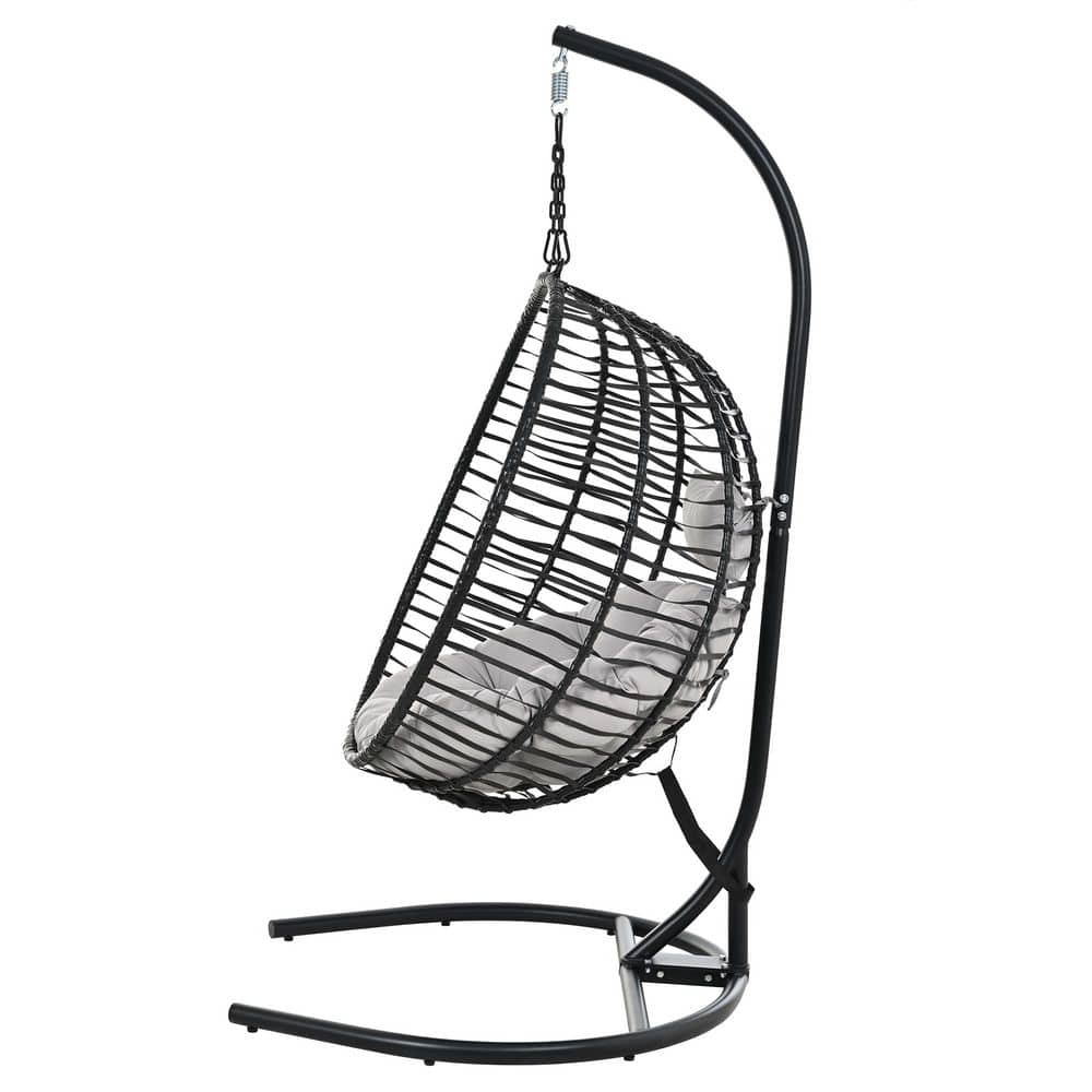 Side view of a black foldable swing egg chair with gray cushions.