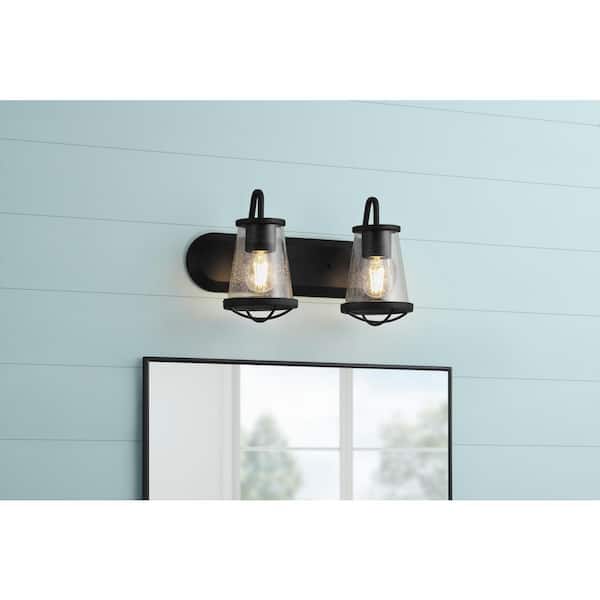 Home Decorators Collection Georgina 18 in. 2-Light Matte Black Industrial Rustic Vanity with Clear Seeded Glass Shades and Cage Accents