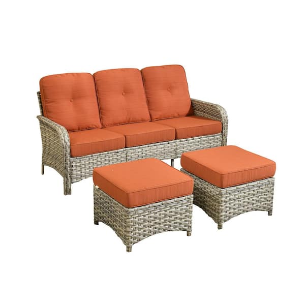 Cove Wicker Outdoor Couch with Orange Red Cushions and Ottoman