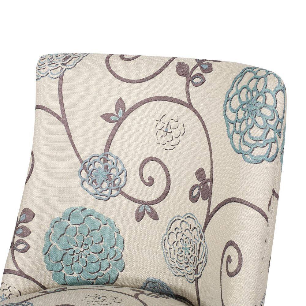 Close-up of the curved backrest of a floral upholstered dining chair.