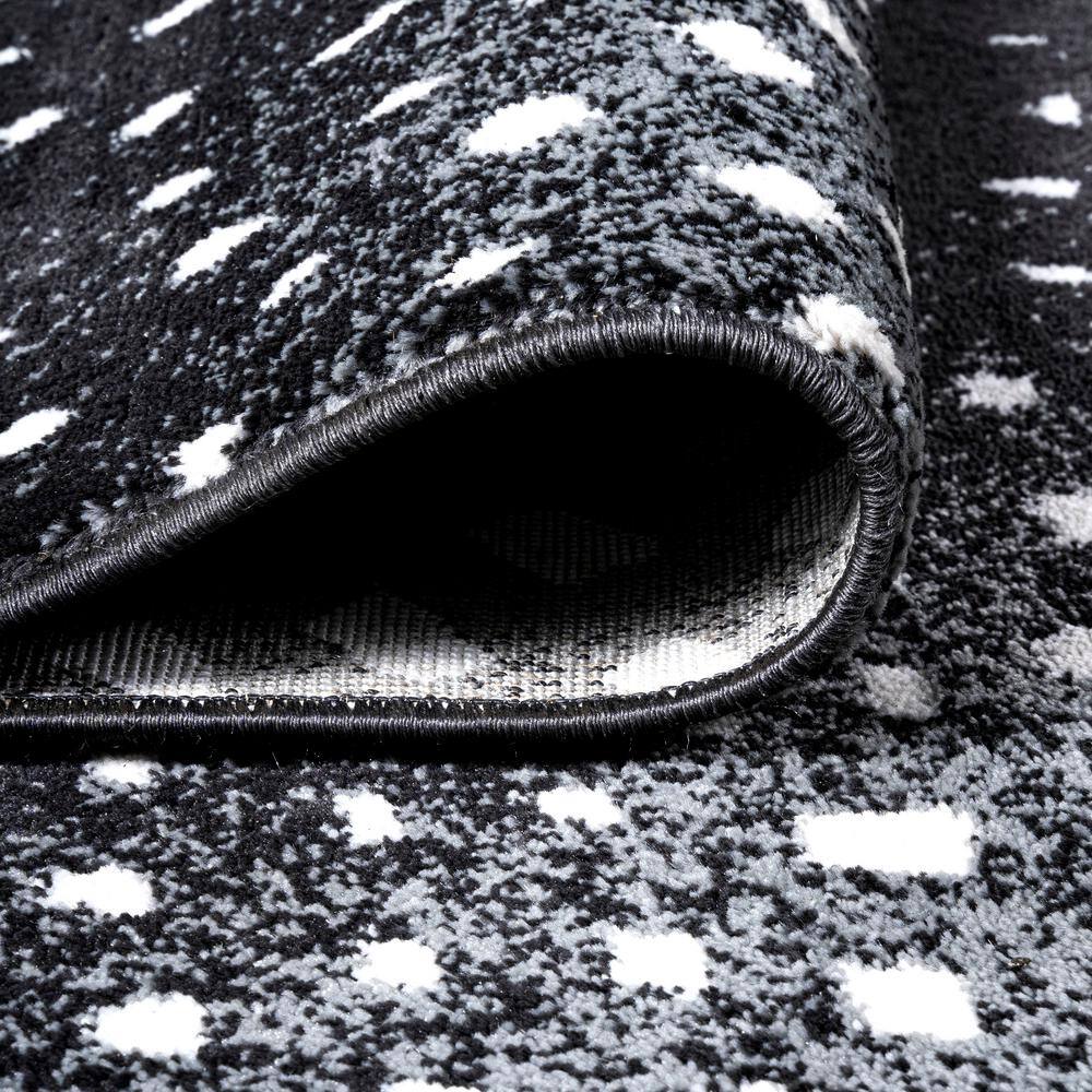 Abstract Antelope 8' x 10' Black and Ivory Synthetic Area Rug