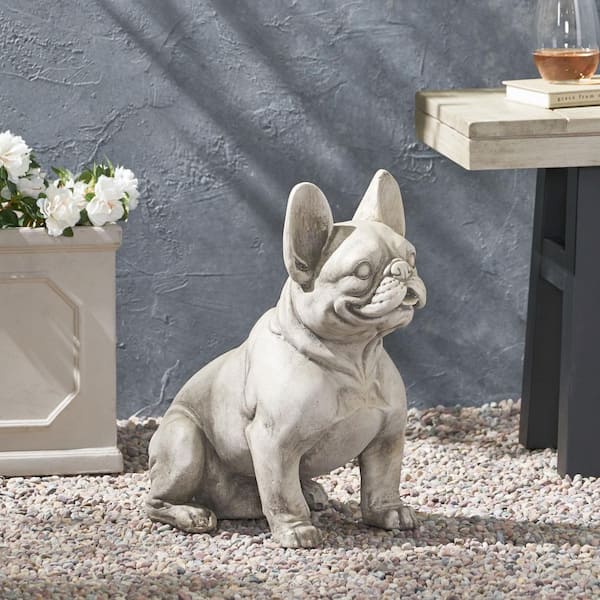 Resin sculpture depicting a white seated French bulldog