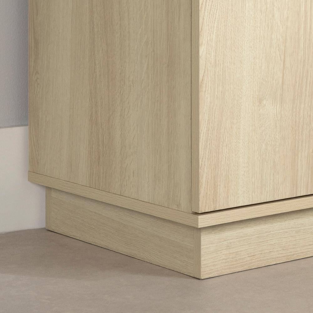 Close-up of the recessed base of the Liora Bleached Oak Bookcase.