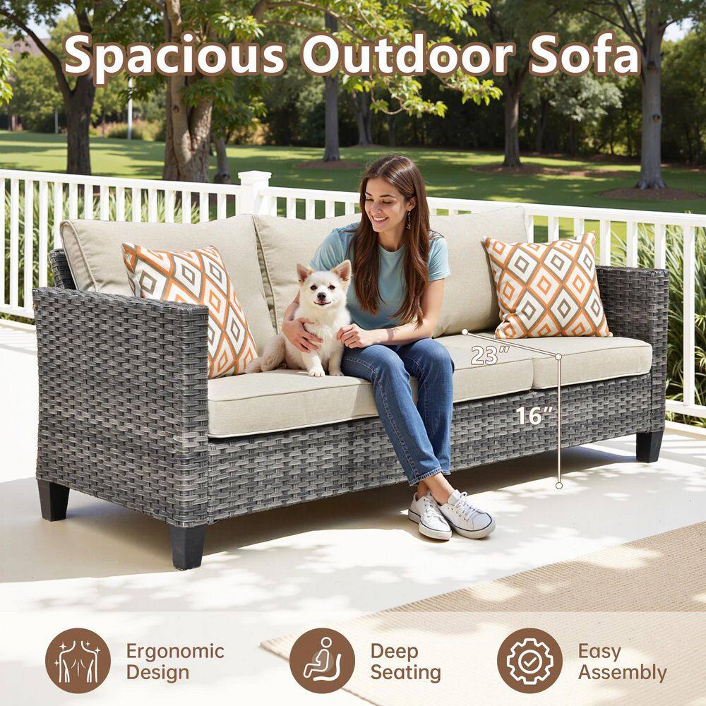 Woman relaxing on an outdoor wicker sofa.