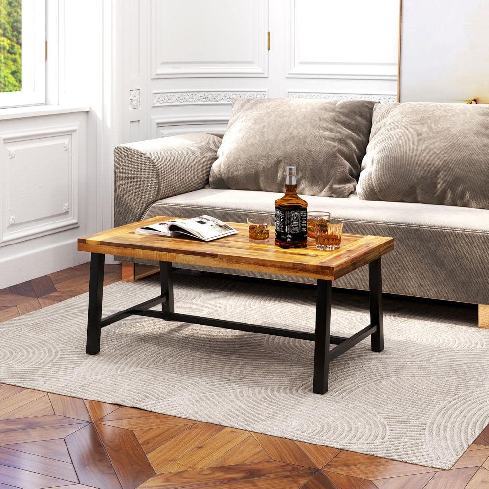 Acacia wood coffee table in a living room setting.
