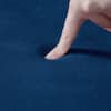 Close-up of the dark blue cushion material on the chair.
