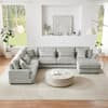 Gray corduroy U-shaped sectional sofa in a bright living space.