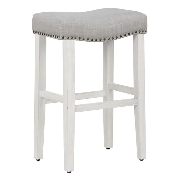 WESTINFURNITURE Jameson 29 in. Bar Height Antique White Wood Backless Nailhead Trim Barstool with Upholstered Gray Linen Saddle Seat