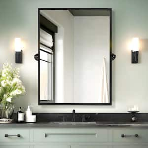 24 in. W x 32 in. H Rectangular Metal Framed Pivoted Bathroom Wall Vanity Mirror in Black