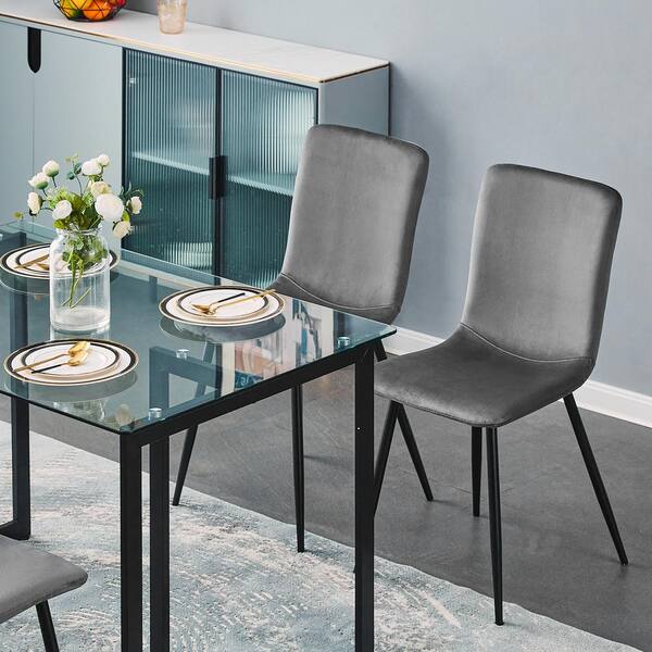 https://images.thdstatic.com/productImages/128c9971-b12f-4bfb-92ff-5ed3063516c5/svn/grey-dining-room-sets-slip-glass-black-leg-scargill-grey-40_600.jpg