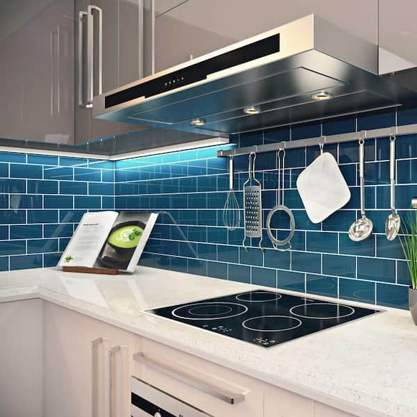 a bright kitchen with teal cabinets, mismatching tile backsplash