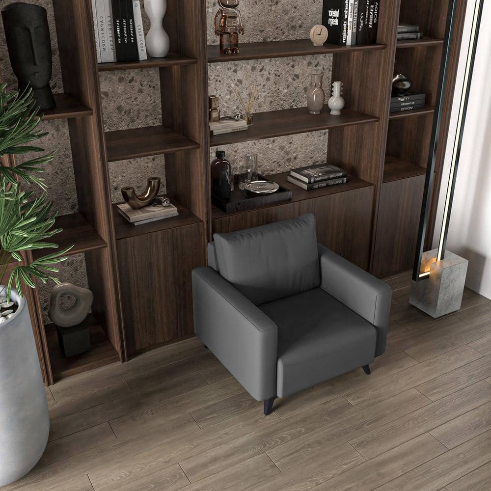 Grey armchair in a room with dark wood shelving.