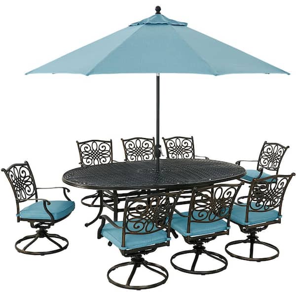 Hanover Traditions 9-Piece Aluminum Outdoor Dining Set with Blue Cushions, 8 Swivel Rockers, Cast-Top Table, Umbrella and Base