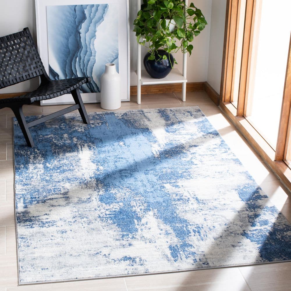 Blue and Ivory Abstract Synthetic Area Rug, 5'3" x 7'6"