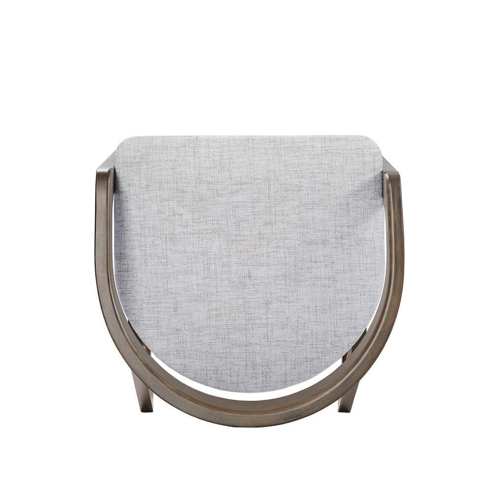 Close-up of the upholstered seat and curved base of a stool.
