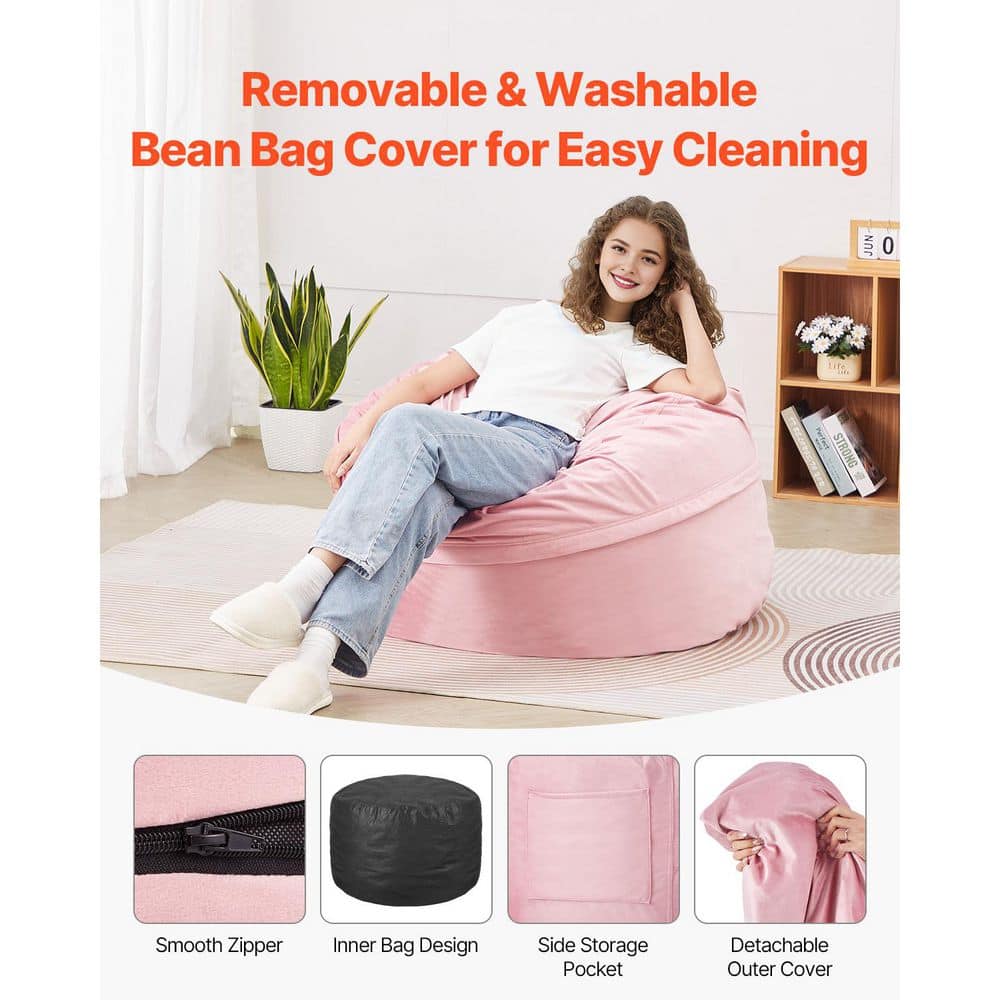 A person sitting on a pink bean bag chair in a living room setting.