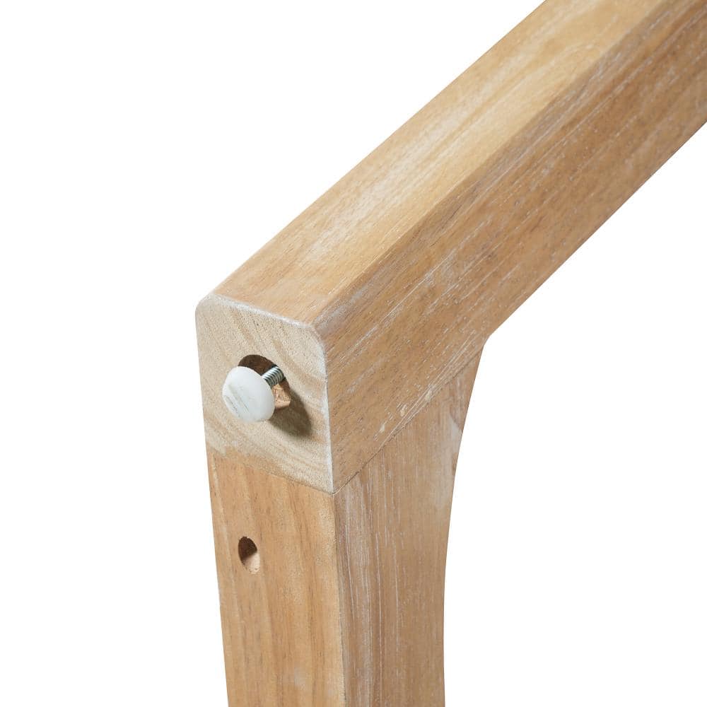 Close-up of a wooden table leg joint with a white cam lock fastener.