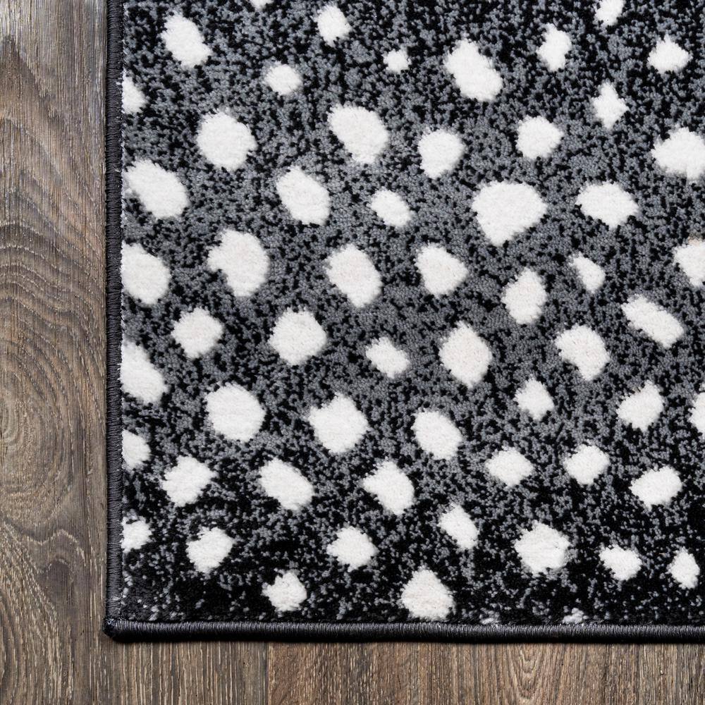 Abstract Antelope 8' x 10' Black and Ivory Synthetic Area Rug