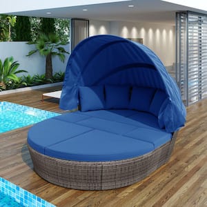 Black Wicker Outdoor Day Bed with Blue Cushions and Retractable Canopy