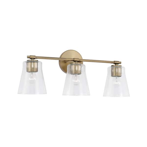 23 in. W x 9.5 in. H 3-Light Vanity in Aged Brass with Clear Seeded Glass