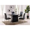 Black dining table set with four chairs in a living room.