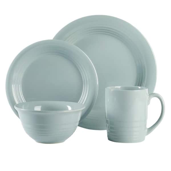Set of Blue Kitchen Utensils in a Ceramic Cup and Plates Stock