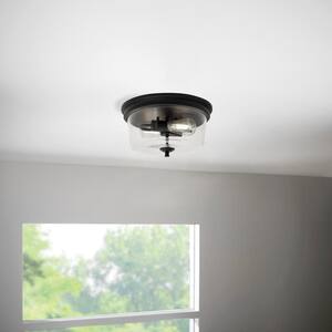 Manor 13 in. Matte Black Round Flush Mount, Industrial Ceiling Light with Clear Glass Shade