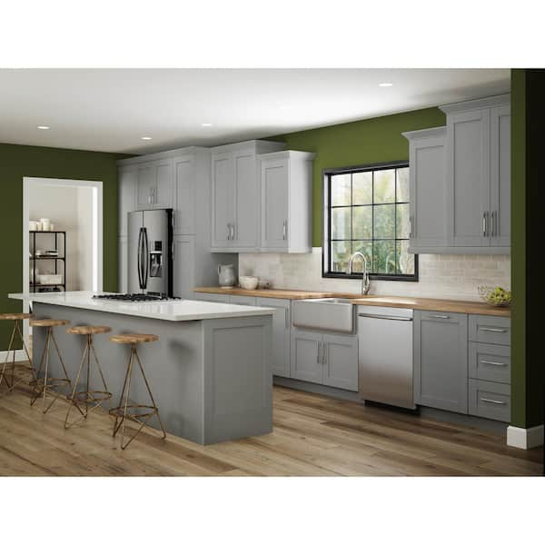 Grey kitchen cabinets against sage green walls in an attic