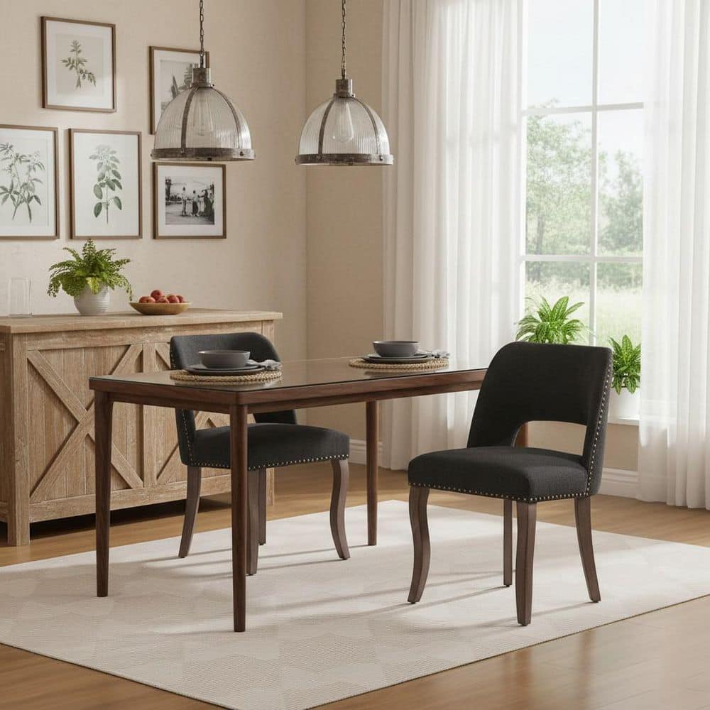 Two charcoal upholstered dining chairs with curved backs in a modern dining room.