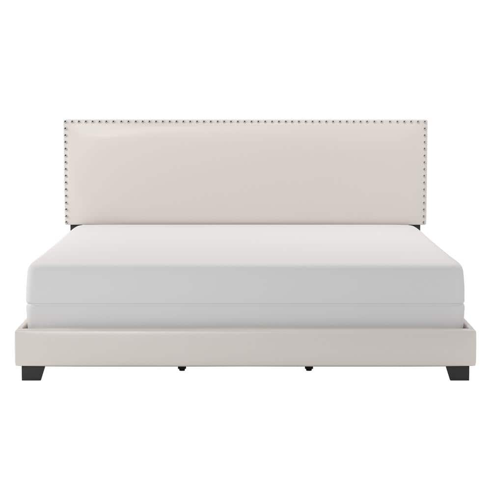 A light beige upholstered bed frame with a white mattress.