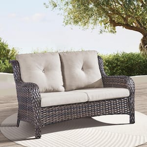 Brown Wicker Outdoor Loveseat with Beige Cushions