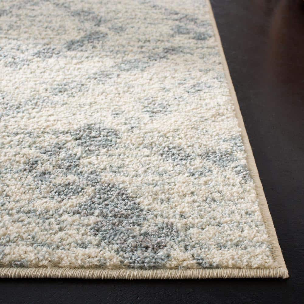 Ivory and Light Blue Geometric 8' x 10' Synthetic Area Rug