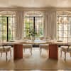 Dining set in a room with arched windows and wooden floor.