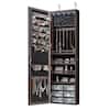 Open brown wood jewelry armoire displaying hanging racks and shelves.