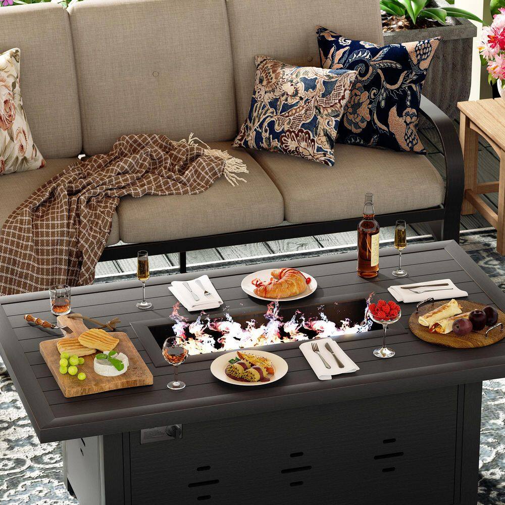 Lifestyle shot of the outdoor conversation set styled with pillows and snacks.
