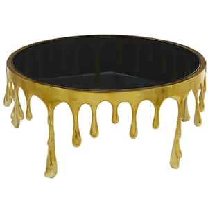 36 in. Gold Medium Round Aluminum Drip Coffee Table with Melting Designed Legs and Shaded Glass Top