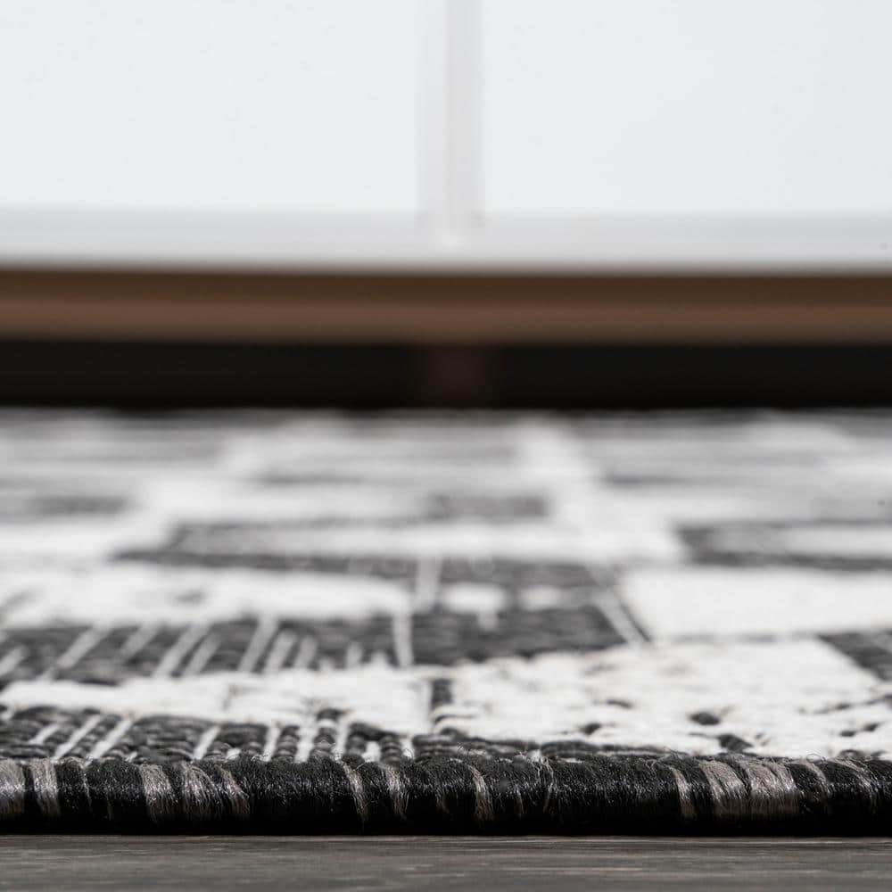5' x 8' Black and Ivory Geometric Synthetic Area Rug