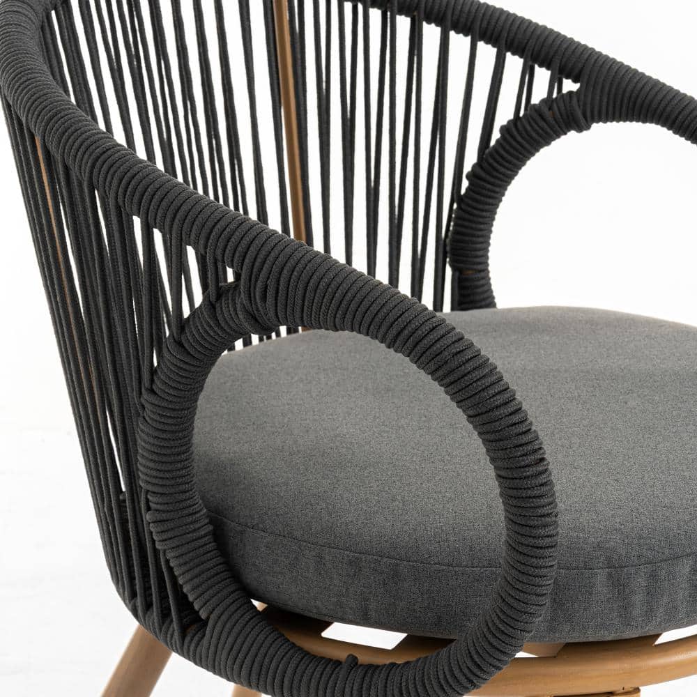 Close-up of the black woven rope detail on a grey dining chair.