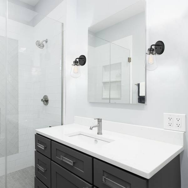 Designers Fountain - Elliott 5 in. 1-Light Matte Black Modern Wall Sconce with Clear Glass Shade