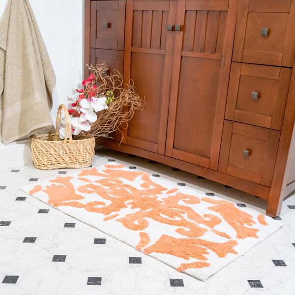 https://images.thdstatic.com/productImages/1d7be014-8e71-4921-939e-ce015ee4e199/svn/white-and-coral-chesapeake-merchandising-bathroom-rugs-bath-mats-37314-c3_600.jpg