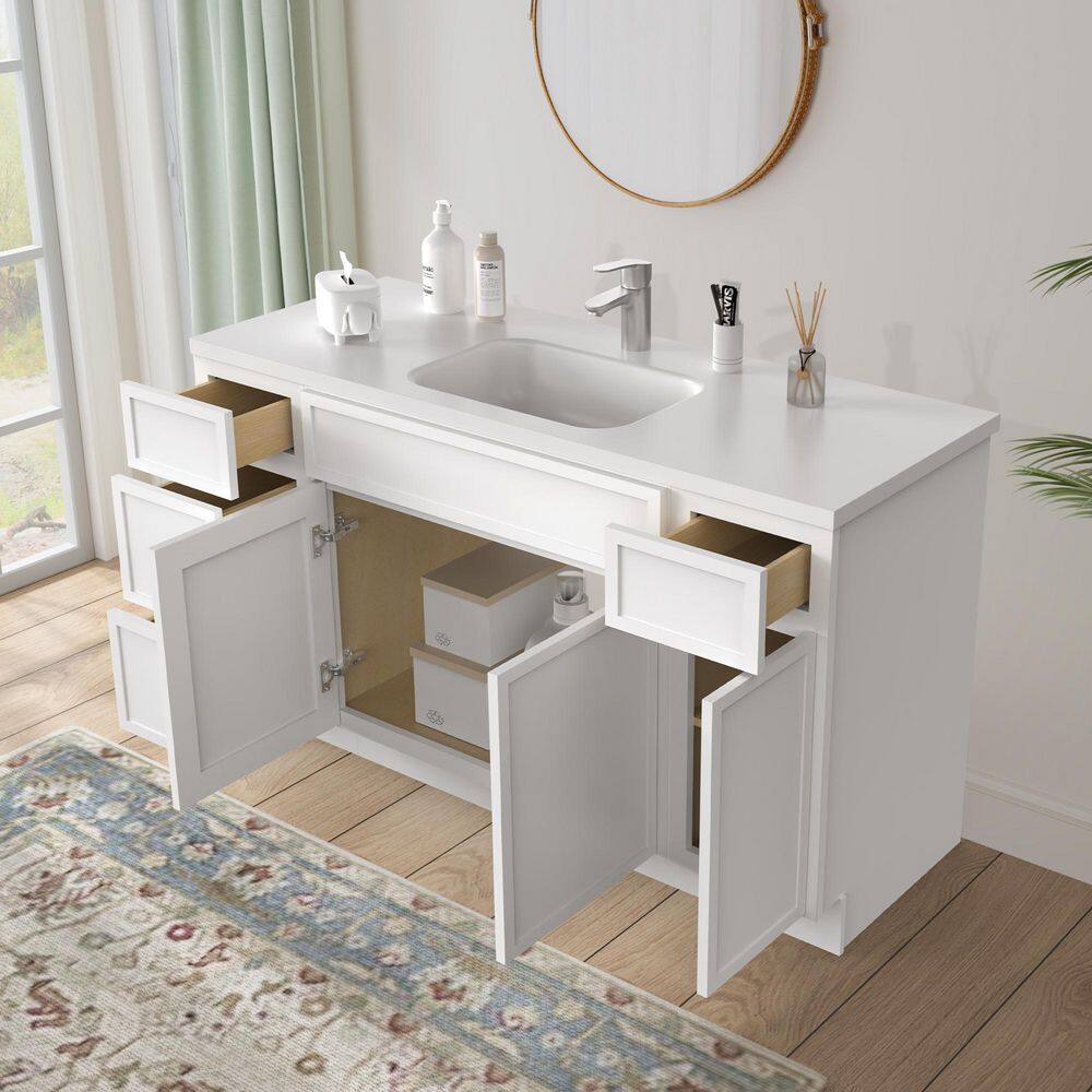 Open white bathroom vanity cabinet showing interior storage.