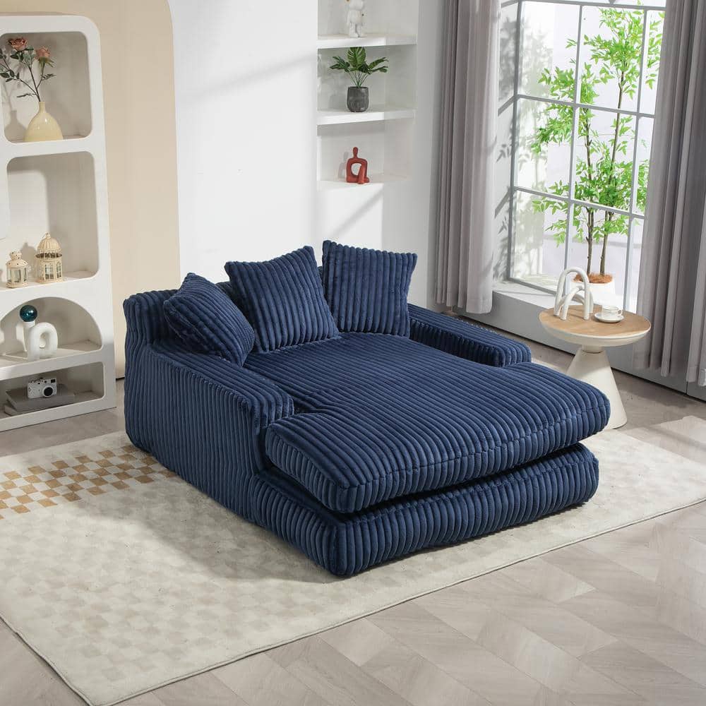 Navy blue corduroy 2-seater loveseat sofa bed with three back pillows.