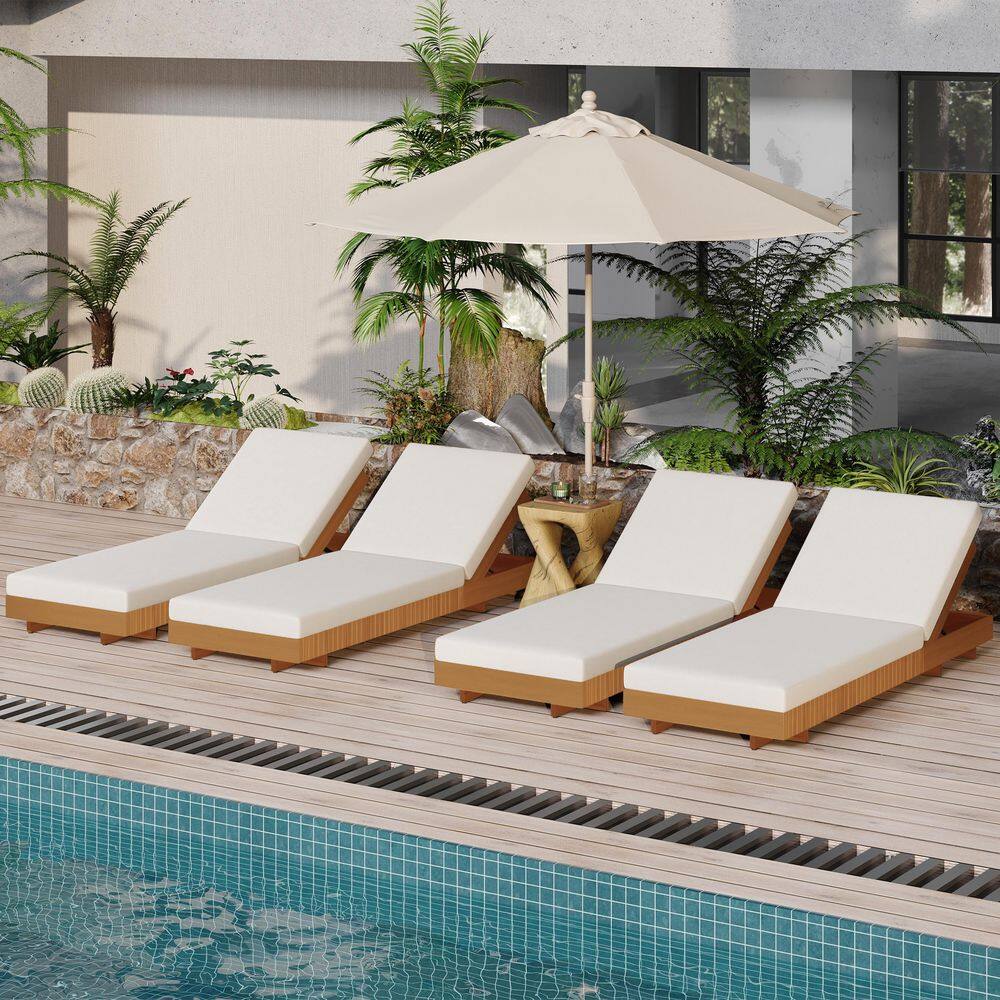 Three wooden chaise lounges set up outdoors under a patio umbrella.
