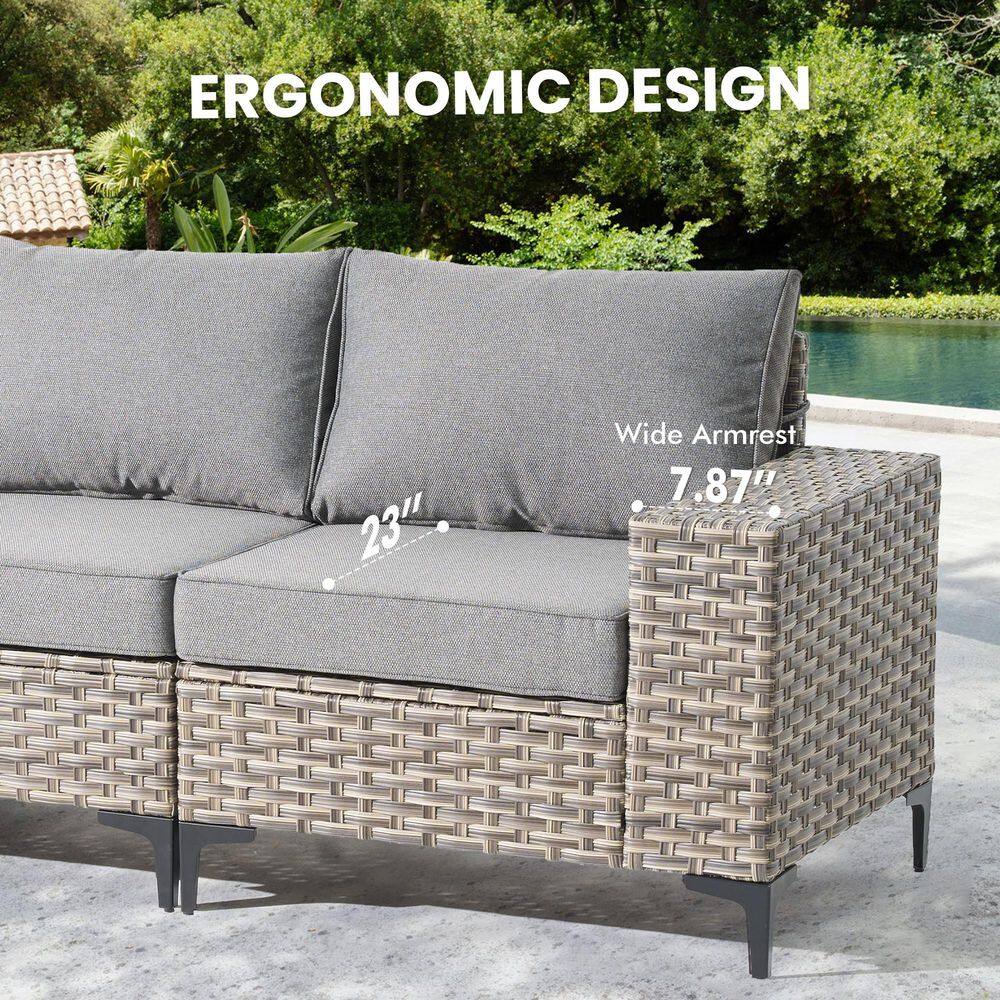 Close-up of the gray wicker sectional sofa showing the wide armrest and seat depth.