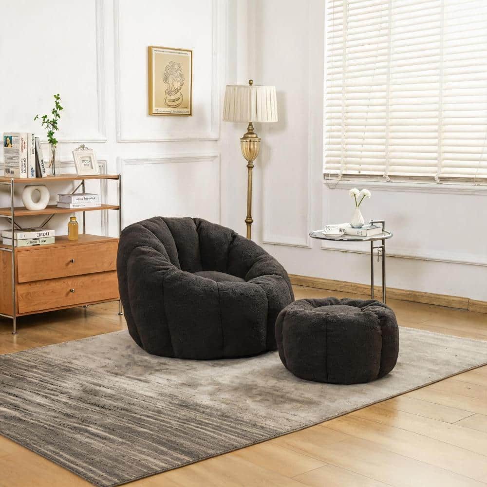 Dark gray bean bag chair and ottoman in a living room.