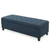 Perspective view of a dark blue storage ottoman bench.