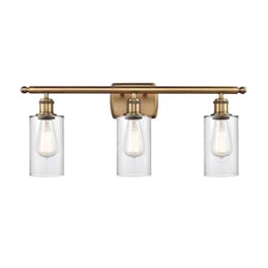 Clymer 26 in. 3-Light Brushed Brass Vanity Light with Clear Glass Shade