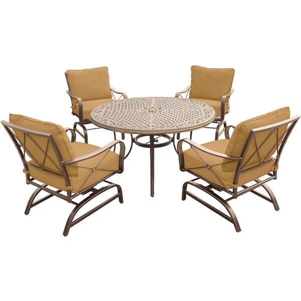 Hanover Summer Nights 5-Piece Outdoor Dining Set with Round Cast-Top Table and Aluminum Rockers with Desert Sunset Cushions