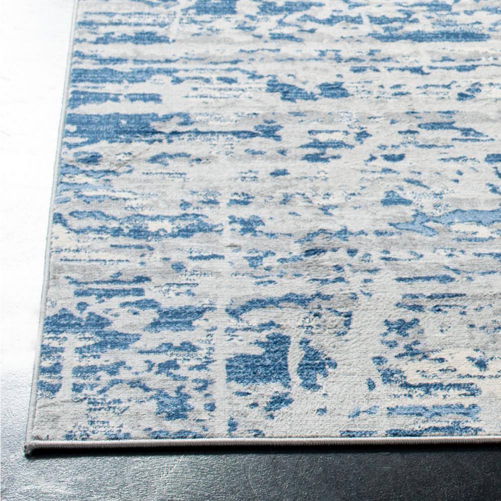 Ivory/Blue Abstract Synthetic 8' x 10' Easy Care Area Rug