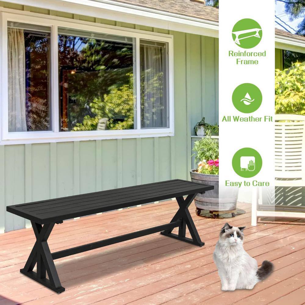 Black metal patio bench on a wooden deck.